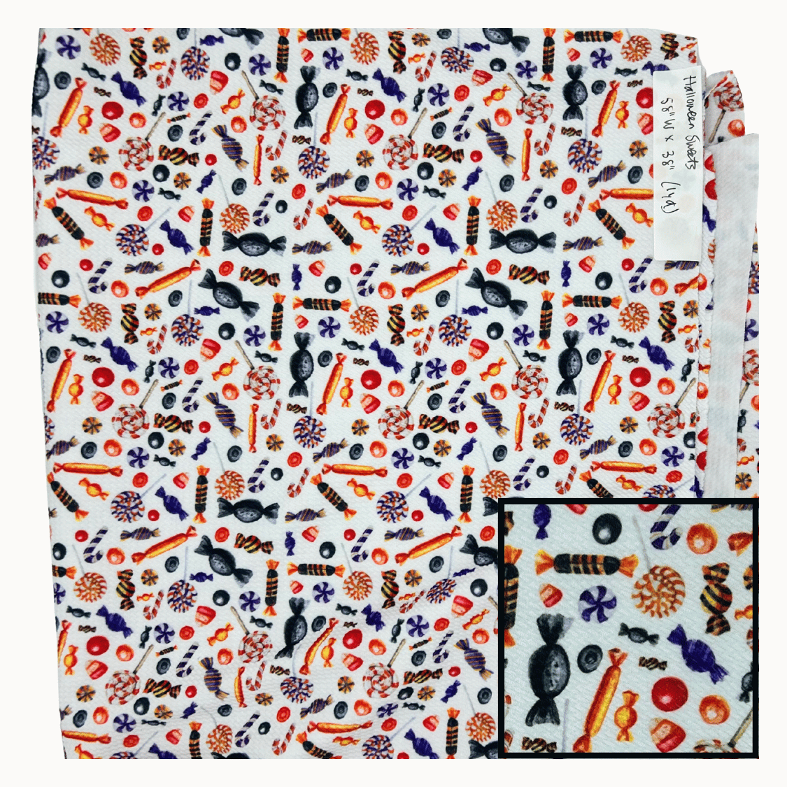 White fabric with colorful candy pattern for Halloween.