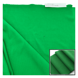 Green fabric with a close-up inset on a white background