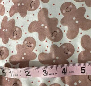 Gingerbread man pattern and a measuring tape indicating dimensions.