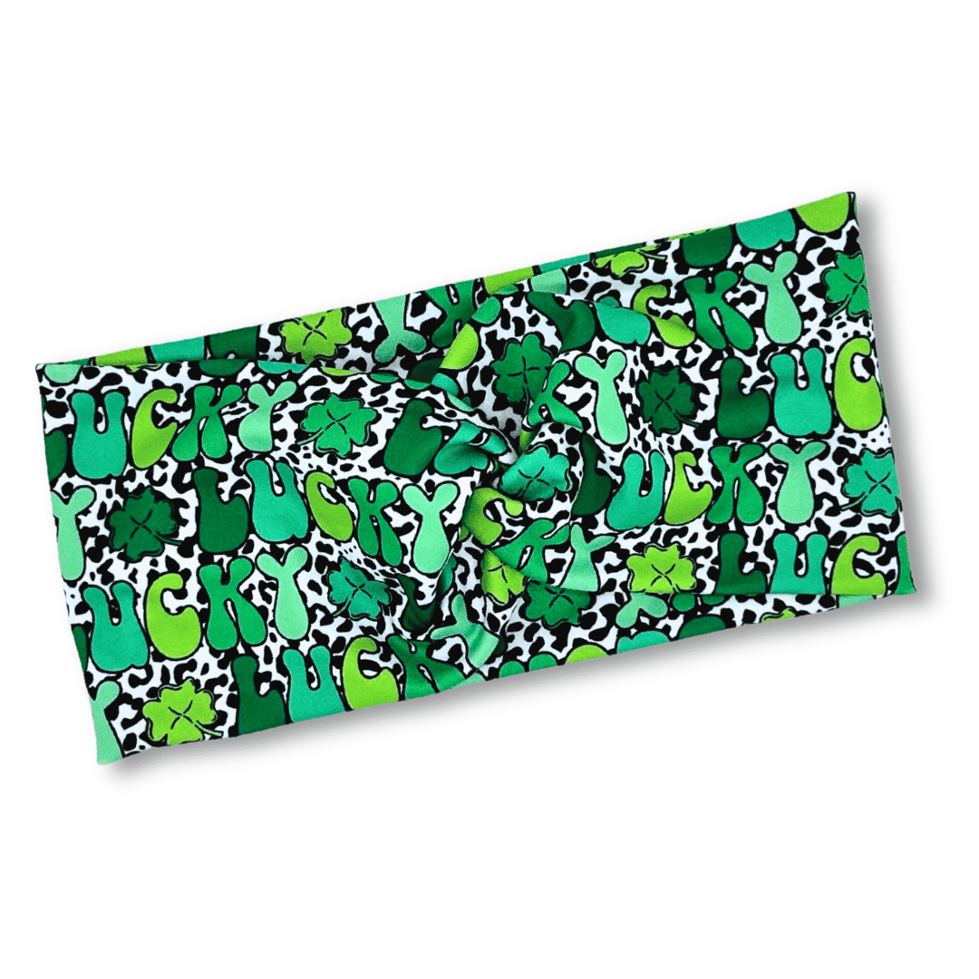 headband with twist feature. lucky words and shamrocks.
