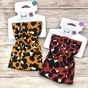 animal print on headband in orange or rust with black and white spots