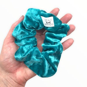 teal velour scrunchie in hand