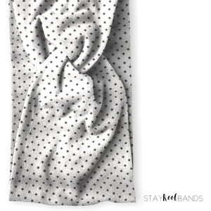 black polka dots on a twist headband